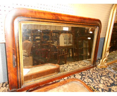 A Victorian red lacquered and gilt scrolling over mantel mirror