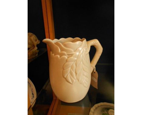 A Clarice Cliff relief moulded jug decorated with leaves