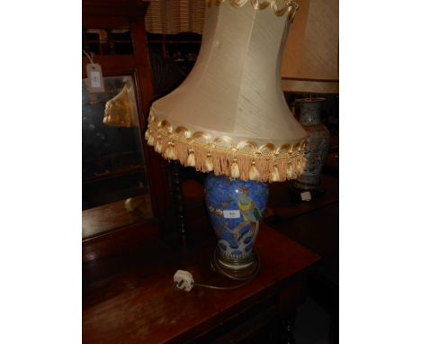 A Chinese blue ground ceramic table lamp decorated with blossoms and branches