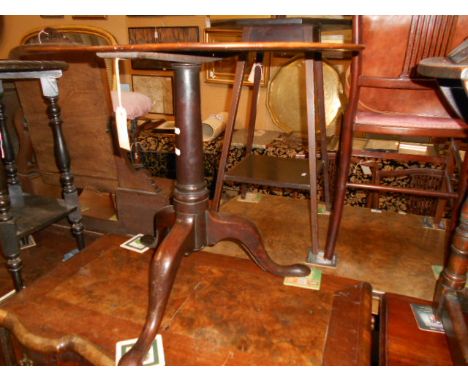A 19th C oval mahogany occasional table raised in a cannon barrel support and tripod base