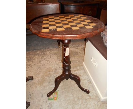 A 19th C pie-crust top games table with inlaid chequered board top raised in a spiral carved column and tripod base