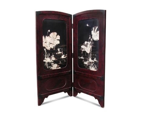 A late 19th/early 20th century bone and mother of pearl inlaid lacquer two fold screen, the mottled red rectangular panels wi