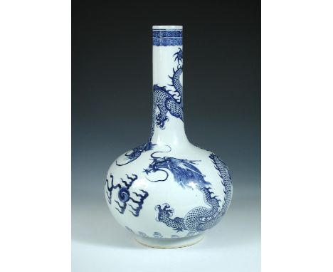 A 19th century blue and white bottle vase, painted with two five clawed dragons head to head on the shoulders above a flaming