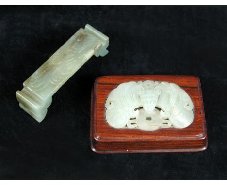 A 19th century nephrite jade brush rest, the rectangular top carved in relief with lingzhih fungus and flanked by trough topp