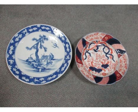 A 19th century Chinese blue and white charger together with another Japanese Imari, the first painted with deer and cranes ab