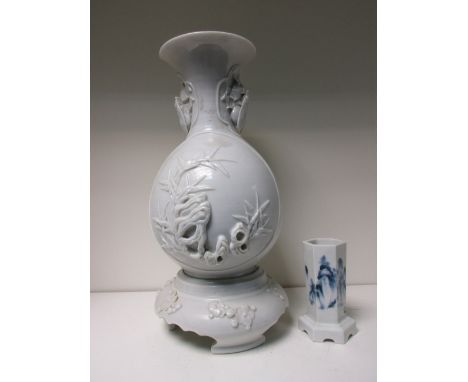 A blue and white vase and a Hirado white vase on stand, the hexagonal sides of the first painted with mountainous landscapes 