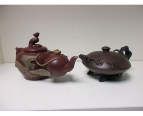 Two Yixing tea pots and covers, the two red clay bodies of one linked by buff clay dragons and clouds, a bird and cash formin