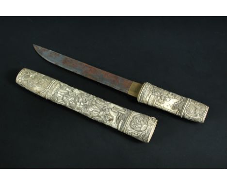A late 19th/early 20th century dagger in carved bone scabbard, relief carvings of Buddhist lions at each end of bands of warr