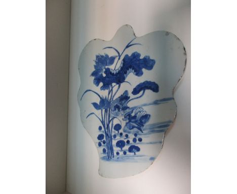 A 19th century blue and white leaf shaped panel painted with two mandarin ducks swimming below lotus and a stem of millet, 27