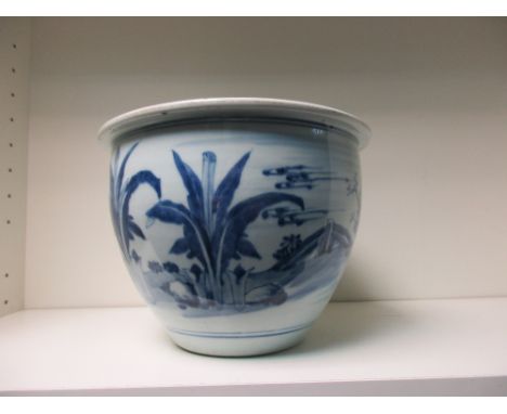 A late 18th/early 19th century Chinese blue and white planter, the flat rim above rounded sides painted with a couple walking