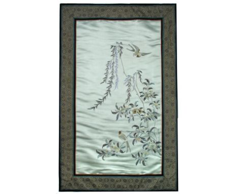 A framed pale olive green panel embroidered with two birds, one flying above willow and the other perched below on the branch