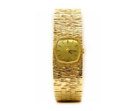 A ladies' 9ct gold Bulova mechanical bracelet watch, c.1970, with a champagne dial with baton hour markers, to intergral tape