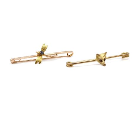 A gold fox head bar brooch,the fox head with ruby set eyes, to a safety pin style bar brooch, tested as approximately 9ct gol