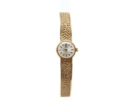 A ladies' 9ct gold Omega mechanical bracelet watch, 17mm diameter with a silvered dial and baton hour markers, to integral te