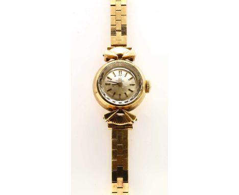 A ladies' 9ct gold Omega mechanical bracelet watch, c.1960, with a silvered dial and baton hour markers, to later 9ct gold br
