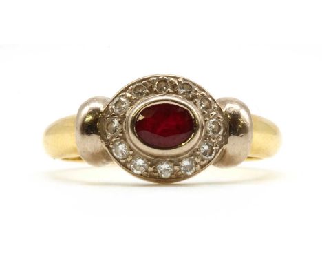 A gold ruby and diamond cluster ring, with an oval mixed cut ruby, rub set, to border of brilliant cut diamonds, grain set to