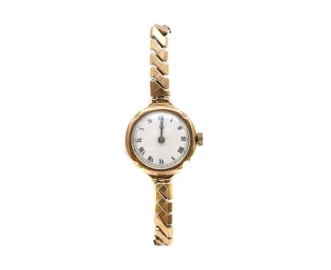 A ladies' 9ct gold pin set mechanical watch head, 26mm diameter with white enamel Arabic numerals to the bezel, a white ename
