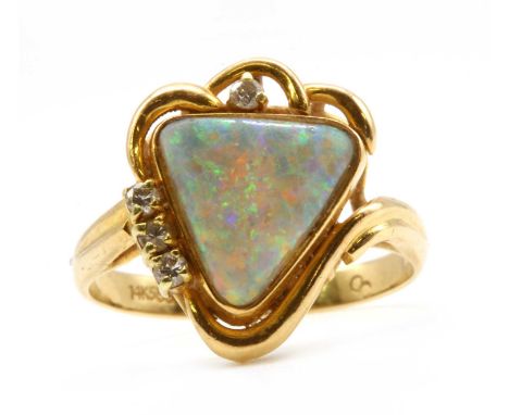 A gold opal doublet and diamond ring, with a triangular opal doublet, rub set, to wire surround claw set with brilliant cut d