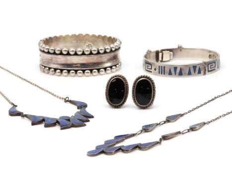 Two Mexican Taxco sterling silver bangles, one with a concave centre to beaded edges, with sprung hinge, the other with inlai