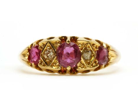 A gold ruby and diamond five stone ring, with graduated oval mixed cut rubies, claw set, alternating with eight cut diamond, 