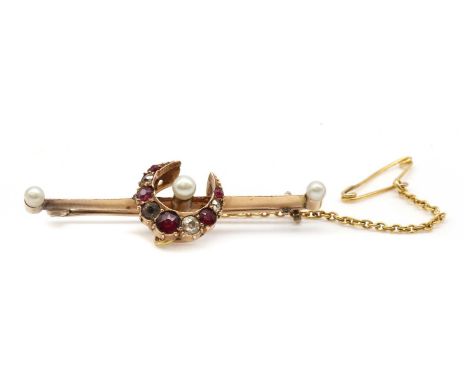A gold ruby, diamond, paste and pearl crescent bar brooch,the crescent with a row of graduated mixed cut rubies and Swiss and