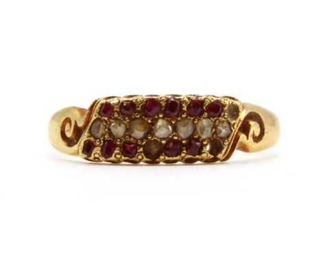 A Victorian 18ct gold diamond and ruby ring, a central row of rose cut diamonds with a row of mixed cut rubies above and belo