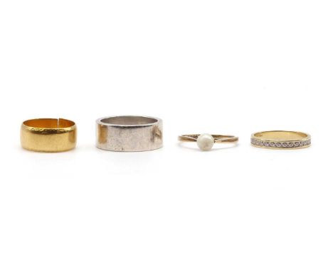A collection of rings, comprising a 22ct gold wedding ring, split, London 1972, 5.25g, a two colour gold wedding ring, tested