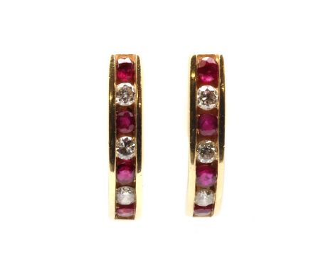 A pair of 9ct gold ruby and diamond 'J' hoop earrings, with alternating round mixed cut rubies and brilliant cut diamonds, ch