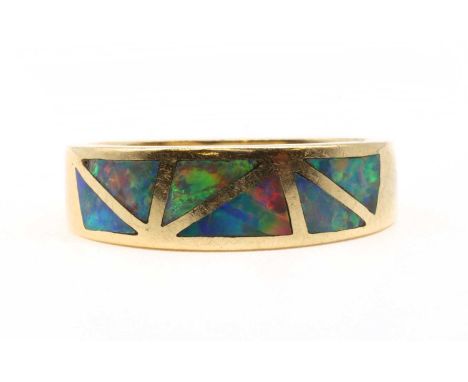 A gold opal ring, the slightly tapered head inlaid with triangular pieces of opal, to a flat section shank, marked 585 14k, t