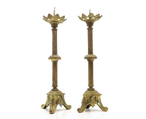 A pair of gilt-brass pricket candlesticks, late 19th/ early 20th century, each with a pierced foliate drip pan, and a tripod 