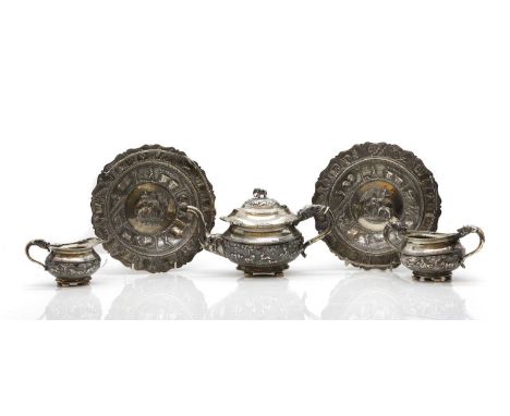 An Indian three-piece silver tea service comprising teapot, sugar bowl and cream jug, all with cast elephant decoration, each