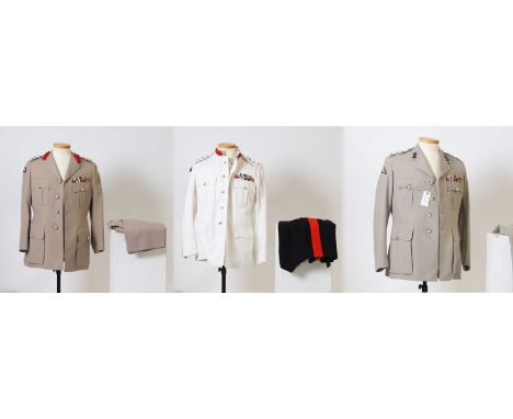 A collection of British Army service uniforms  worn by a former Colonel in the Royal Engineers, comprising two light khaki dr
