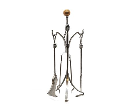 An Arts and Crafts set of three fire tools, c.1900, on a stand, 65cm high