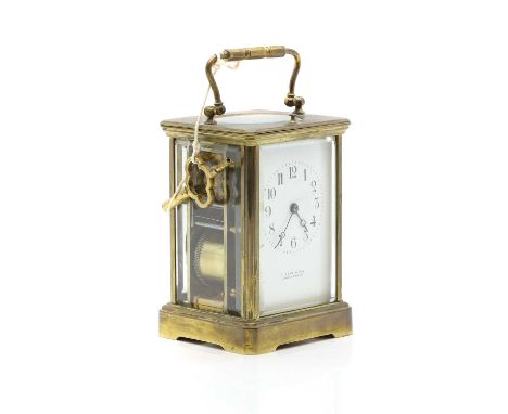 A brass cased carriage clock having white enamel dial inscribed Furber &amp; Son, Cheltenham, with gong strike movement13cm h