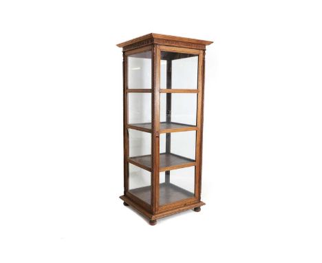 A Victorian-style wooden display cabinet, 20th century, glazed on four sides, flanked with carved rope twist decoration, with