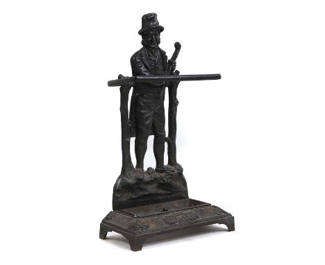 A cast iron stick or umbrella stand, 19th century, Irish, in the form of a man holding a shillelagh, inscribed 'Ireland' and 