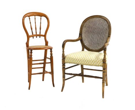 A walnut and beechwood open armchair  19th century, French, the oval cane back above stuff over seat on stretchered turned su