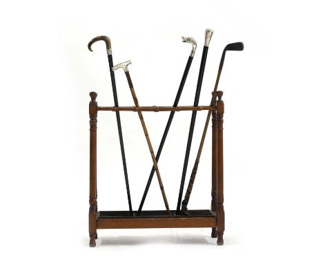 A mahogany stick stand, 19th century, complete with silver mounted walking sticks, and a Haskins Hoylake hickory shafted golf