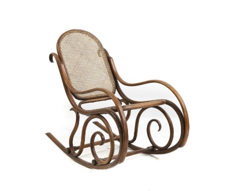 A Thonet bentwood rocking chair late 19th century, the arched cane panel back and seat on bentwood scrolling frame, branded T