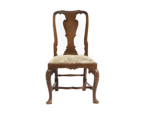 A walnut dining chair early 18th century, with vase splat back, drop-in seat on leaf carved cabriole legs,56cm wide54cm deep9