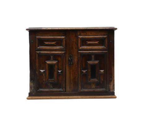 A mahogany spice chest, 18th century, fitted pair of geometrically moulded doors enclosing an arrangement of drawers,50cm wid