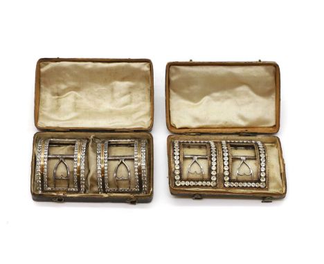 Two pairs of cased shoe buckles late 18th to early 19th century, both silver mounted, inset with cut paste stones, to brass b