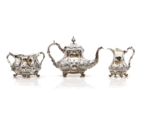 A silver three piece tea service,  by Walker & Hall, Sheffield 1898, having 'C' scroll and acanthus decoration on scroll feet