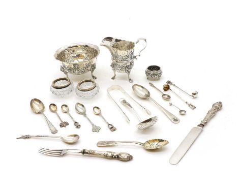 A collection of silver items comprising a silver cream jug and sugar bowl, worn hallmarks, with embossed foliate decoration, 