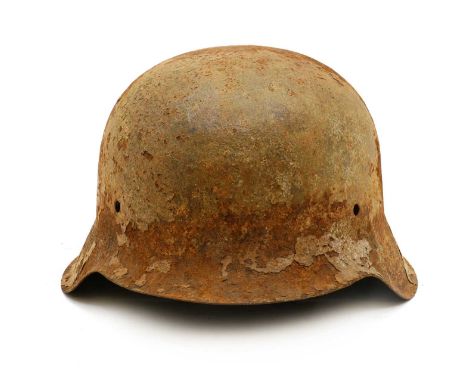 A German WWII M42 steel military helmet or Stahlhelm  unmarked, 24cm wide 29cm deep 17cm high  Shipping Disclaimer:  Buyers m