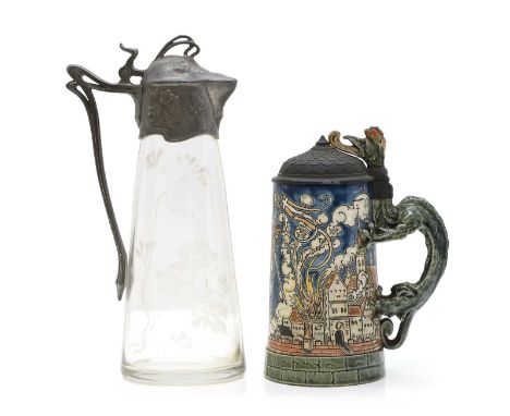 A Geshutzt galzed stoneware beer stein, with an elaborate dragon handle, incised decoration with a verse and a town in flames