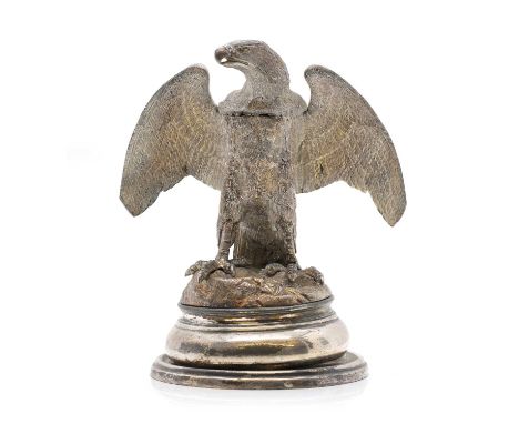 A silver-plated inkwell, late 19th to early 20th century, in the form of a standing eagle, hinged at the head, on a naturalis