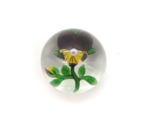 A Baccarat glass 'pansy' paperweight c.1850, set with a purple and yellow pansy, all within a clear crystal glass dome with a