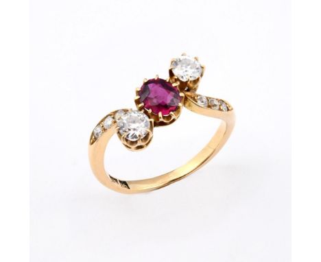 A RUBY AND DIAMOND THREE STONE RING. the oval-shaped ruby is set with two circular-cut diamonds, with three circular-cut diam