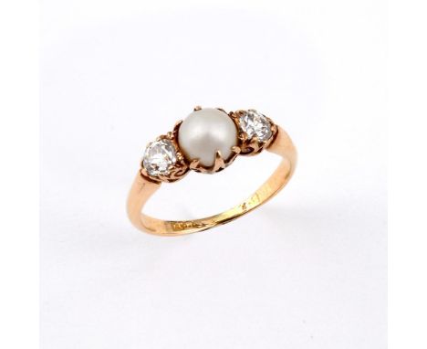 A PEARL AND DIAMOND THREE STONE RING. the untested pearl is set with two old-cut diamonds in yellow gold. Size L.  **BP 22.5%